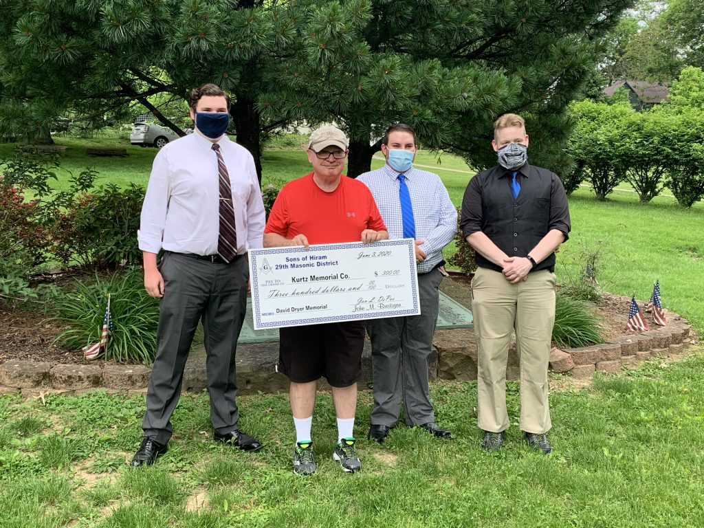 Jacob Beabout, Mayor Michael Gomber, Brandon Coffman, Patrick Mounts present a check for the Dryer Bench