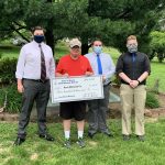 Jacob Beabout, Mayor Michael Gomber, Brandon Coffman, Patrick Mounts present a check for the Dryer Bench