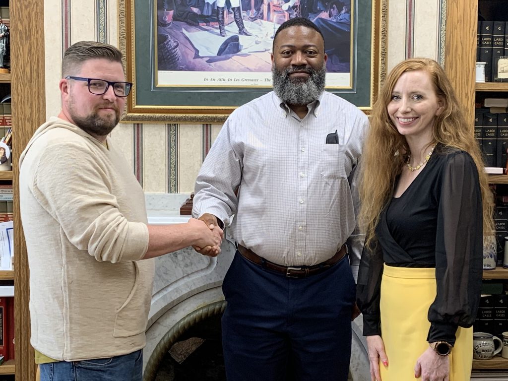 Council member Joseph Fulton shaking hands with Mayor Nixon with Alyssa Curry-Broderick 