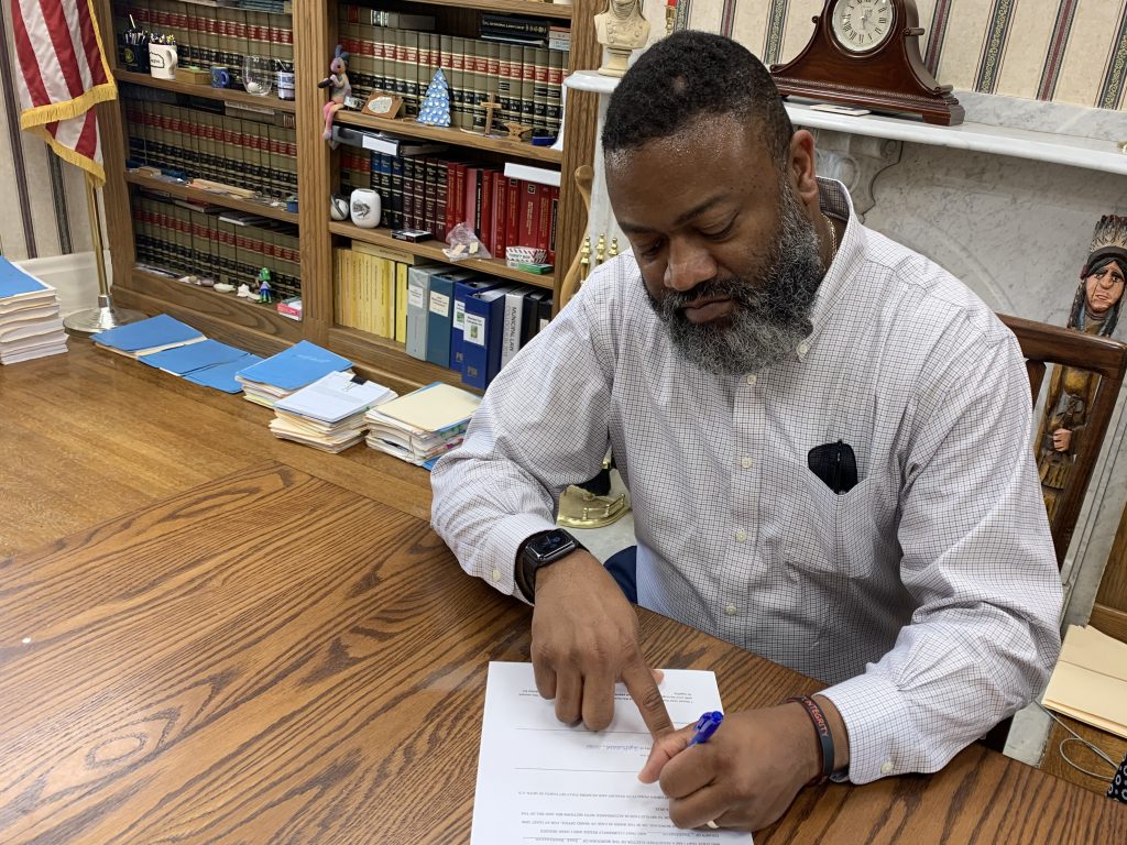 Demond Nixon signing paperwork as the new Mayor of East Washington Borough